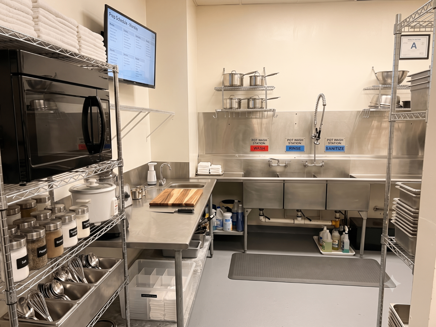 Bright shared commercial kitchen in Jeffersonville with stainless steel prep stations